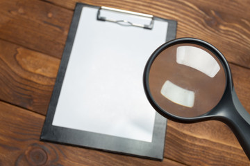 white paper clipboard on wood background