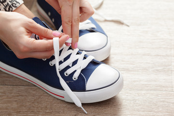 Woman tying shoelaces