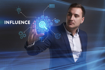 Business, Technology, Internet and network concept. Young businessman working on a virtual screen of the future and sees the inscription: Influence
