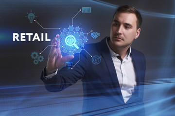 Business, Technology, Internet and network concept. Young businessman working on a virtual screen of the future and sees the inscription: Retail