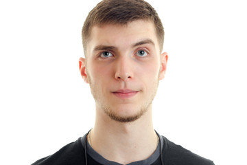 Portrait of a young handsome guy who surprised looks into a camera close-up