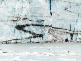 Glacier face with foliation pattern and black streaks