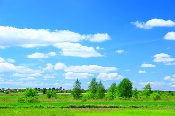 Fototapeta na wymiar Countryside landscape with agriculture field, village and blue sky with clouds