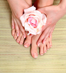 Obraz na płótnie Canvas pedicure on legs and beautiful manicure on hands closeup