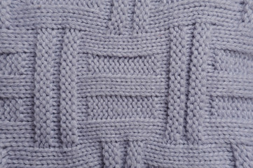 Fototapeta premium A beautiful knitted surface of blue color, close up