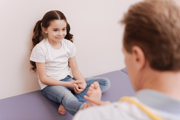 Adorable little lady laughing at doctors office