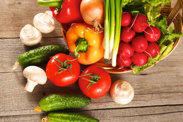 Composition with assorted raw organic vegetables wooden table