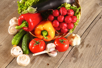 Composition with assorted raw organic vegetables wooden table