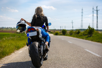 Portrait of a beautiful woman and a motorcycle of speed