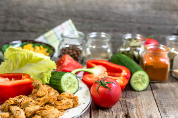 Preparing tortilla with chicken stripes and vegetables, homemade cooking recipe