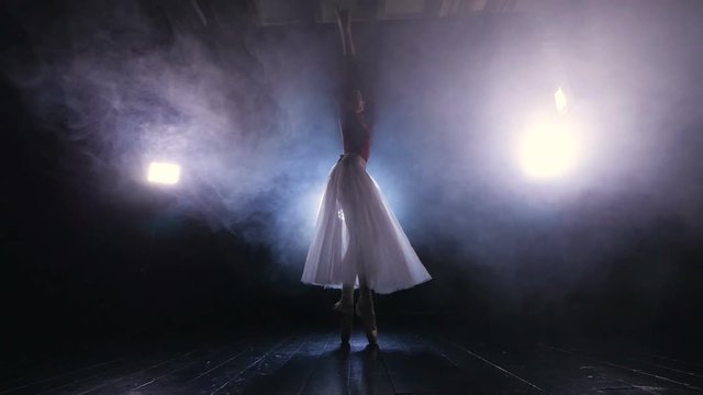 Unrecognised ballet dabcer dancing in the fog. Dolly shot. HD.