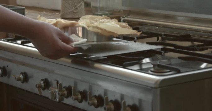closeup of man's chef hand take out a cake from oven