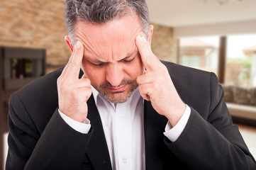 Closeup of frustrated realtor suffering from headache