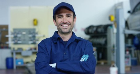 Portrait of a young beautiful car mechanic in a car workshop, in the background of a car service Concept repair of machines, fault diagnosis, repair specialist, technical maintenance on-board computer