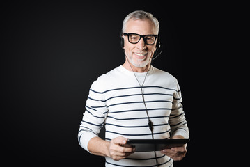 Positive delighted bearded man wearing glasses