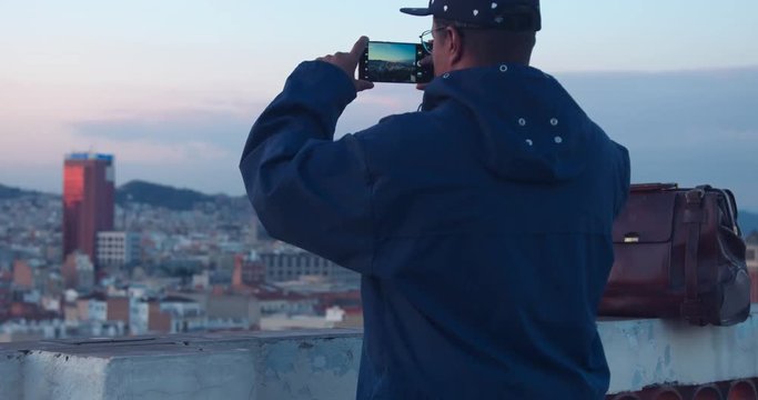 black african american treveler makes a city panorama photos on smartphone