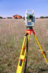 Total station. Survey Instrument geodetic device. Fall time land surveying, set in field. Modern surveyor equipment, used in surveying and building construction for measurement, at construction site.