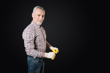 Portrait of positive man keeping arms bent in elbow