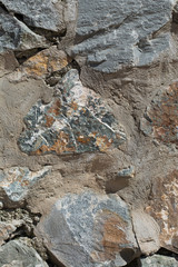 Texture of the wall is made of pieces of decorative granite stone, mixed with concrete