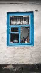 Minimalism scene with a Side wall of damaged building with blue old vintage window