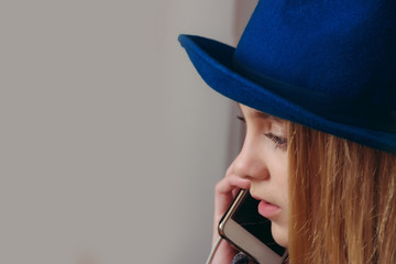 phone call of woman in hat speaking on mobile phone