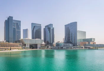 Poster Al Maryah island in Abu Dhabi is being dominated by several skyscrapers containing the Four seasons hotel or the Galleria mall. © dudlajzov