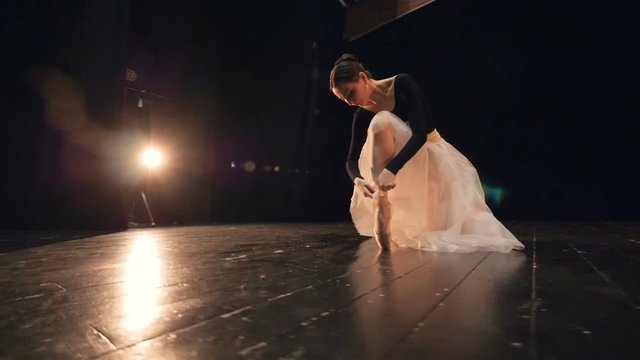 Close-up of the professional ballerina putting on pointe shoes. Close-up. Portrait. Dolly. HD.