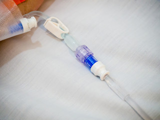 patient hand on IV drip with saline solution, fluid replacement therapy