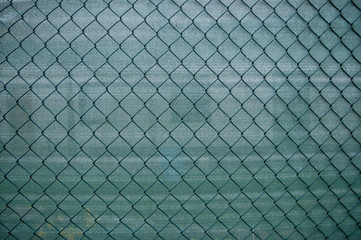 Green metal grid with a back green background