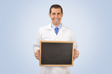 Portrait of a male with lab coat standing and smiling with chalkboard with copy space