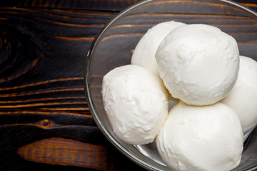 Mozzarella In a glass plate on wooden background
