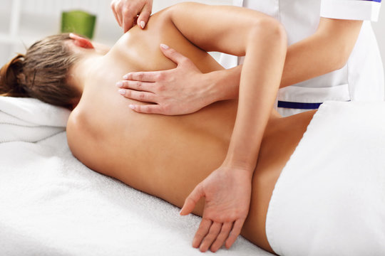 A picture of woman having back therapy