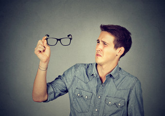 Man with glasses having eyesight problems