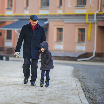 Grandpa and his grandson on a city walk in Kyiv