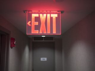 Glowing red exit sign. - Powered by Adobe