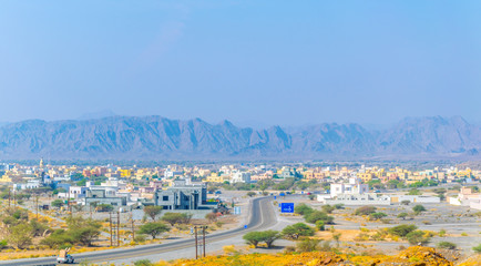 View of an oasis and a village under the Hajar mountains range in Oman.