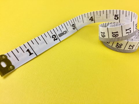 Tape measure on a yellow surface