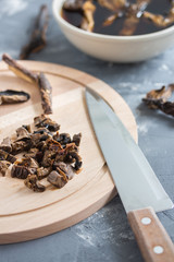Mushroom soup cooking. Slicing mushrooms on a wooden board. Soaking mushrooms.