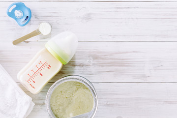 Feeding bottles and baby milk on wooden table