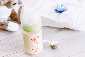 Feeding bottles and baby milk on wooden table