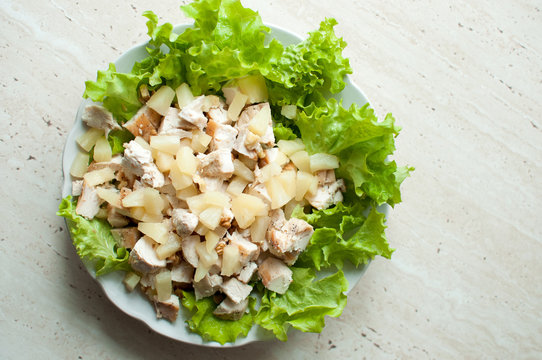 Hawaiian Salad In The Plate. Chopped Ruddy Chicken Breasts With Leaf Salad, Pieces Of Pineapple And Crushed Walnut.