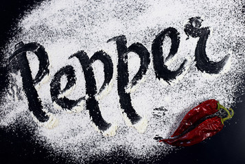 The inscription on the flour. Pepper. Black background