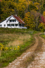 Fototapeta na wymiar Abandoned Farm House with Winding Dirt Road - Autumn / Fall Colors - Vermont