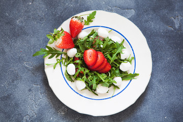 salad with mozzarella cheese, arugula and strawberry