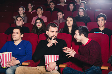 The guy in the cinema watching a movie interferes with conversation