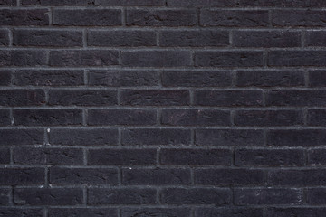 Close-up of anthracite-black brick wall texture.