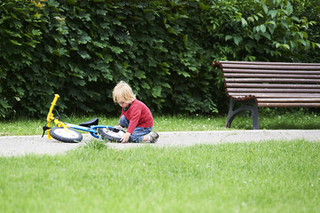 Happy toddler boy riding bike. Kids enjoying a bicycle ride. Sport concept. First bike for little child. Active toddler kid playing and cycling outdoors.