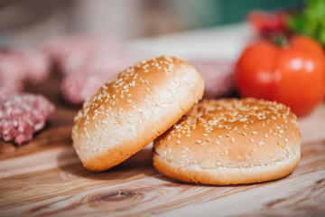 close up view of freshly baked bread for burgers on wooden tabletop