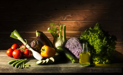 vegetables and olive oil on the wooden table