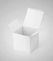 Open white cardboard box on gray background with clipping path. White paper box with reflection